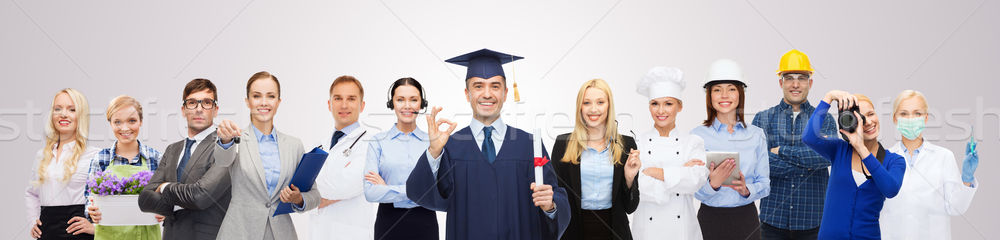 Stock photo: happy bachelor with diploma over professionals