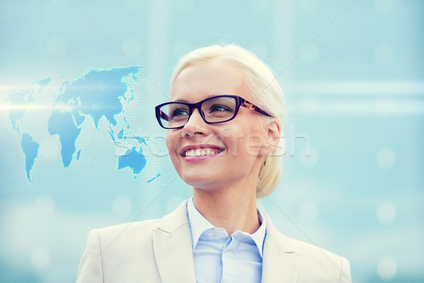 young smiling businesswoman in eyeglasses outdoors Stock photo © dolgachov