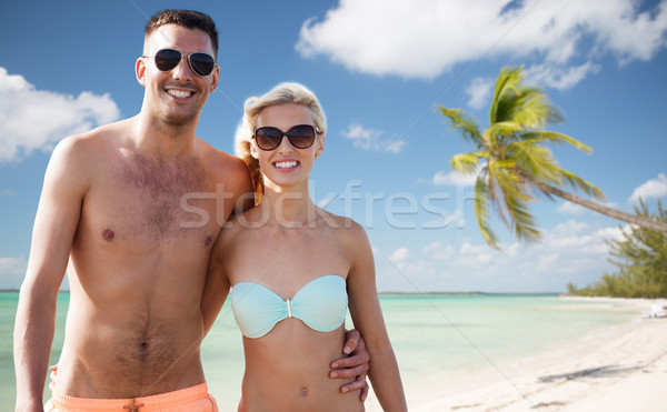 happy couple in swimwear hugging over summer beach Stock photo © dolgachov