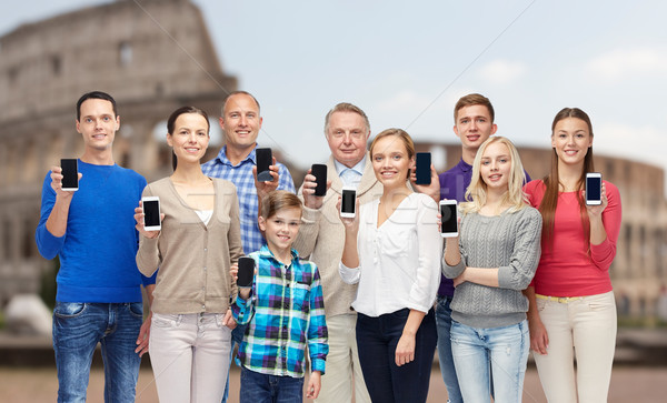group of people with smartphones over coliseum Stock photo © dolgachov