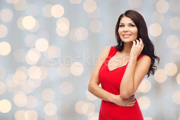 beautiful sexy woman in red dress over lights Stock photo © dolgachov