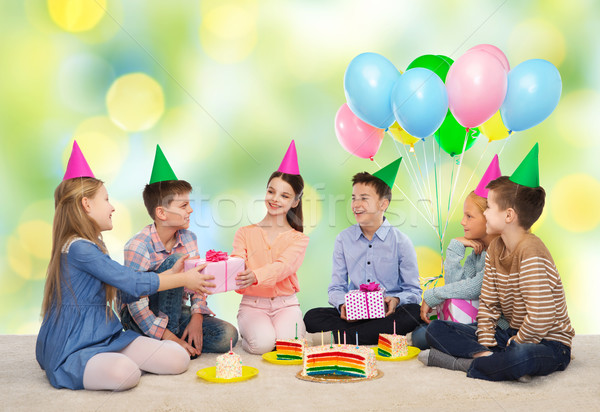 happy children giving presents at birthday party Stock photo © dolgachov