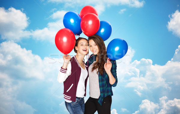 happy teenage girls with helium balloons over sky Stock photo © dolgachov