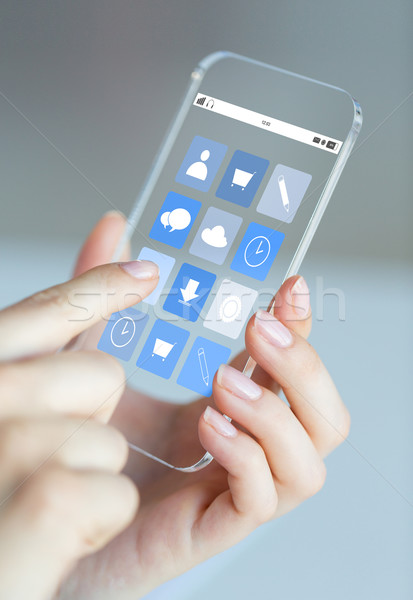 Stock photo: close up of woman with app icons on smartphone