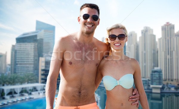 happy couple in swimwear over dubai city waterside Stock photo © dolgachov