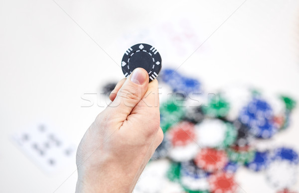 close up of male hand holding casino chip Stock photo © dolgachov