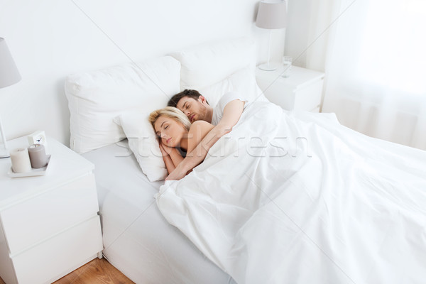 happy couple sleeping in bed at home Stock photo © dolgachov