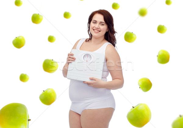 happy young plus size woman holding scales Stock photo © dolgachov