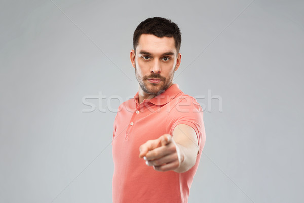 angry man pointing finger to you over gray Stock photo © dolgachov