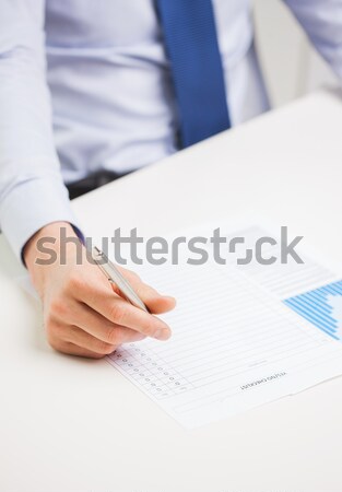 close up of businessman hand with charts in office Stock photo © dolgachov