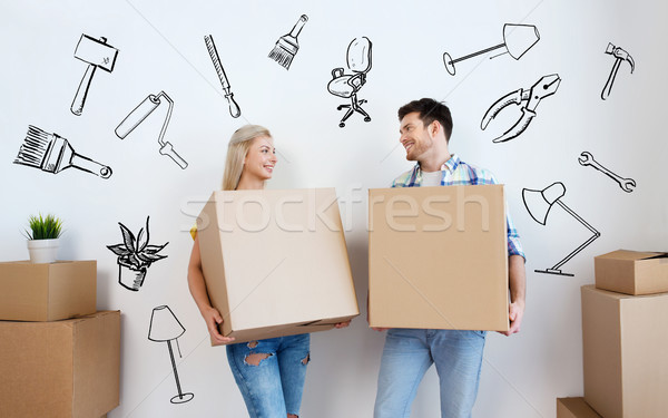 smiling couple with big boxes moving to new home Stock photo © dolgachov