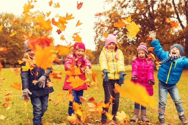 happy children playing with autumn leaves in park Stock photo © dolgachov