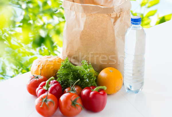 close up of paper bag with vegetables and water Stock photo © dolgachov