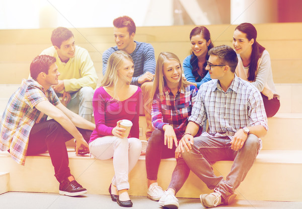 group of smiling students with paper coffee cups Stock photo © dolgachov