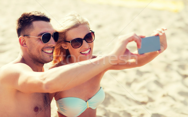 happy couple in swimwear walking on summer beach Stock photo © dolgachov