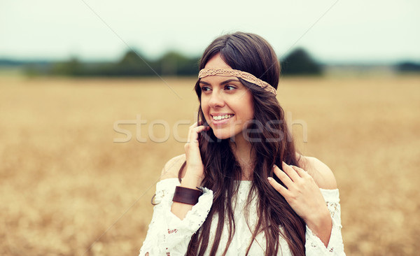 Stock photo: smiling young hippie woman on cereal field