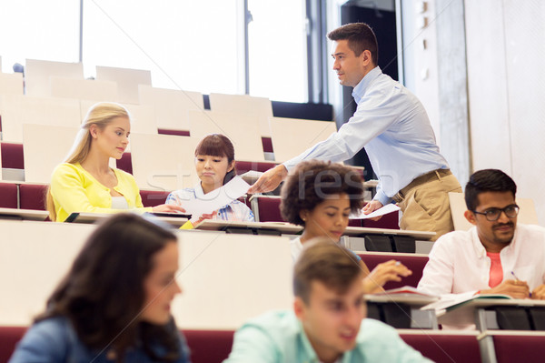 Stock photo: teacher giving test to students on lecture