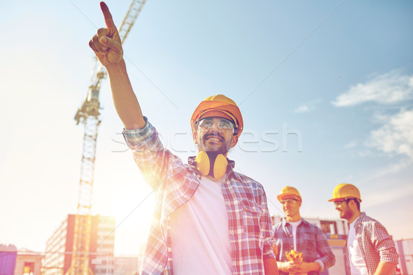 builders pointing finger aside on construction Stock photo © dolgachov