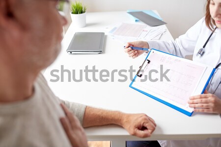 doctor showing cardiogram to old man at hospital Stock photo © dolgachov