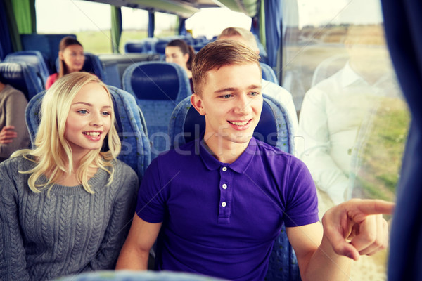 happy teenage couple or passengers in travel bus Stock photo © dolgachov