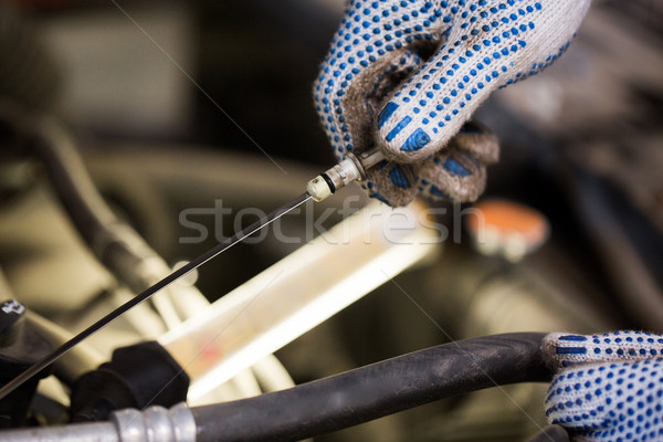mechanic with dipstick checking motor oil level Stock photo © dolgachov