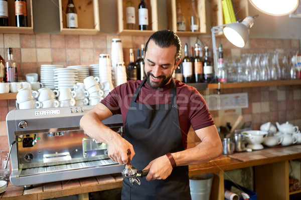 barista with holder and tamper making at coffee Stock photo © dolgachov