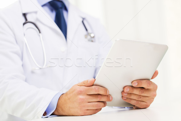 male doctor in white coat with tablet pc Stock photo © dolgachov