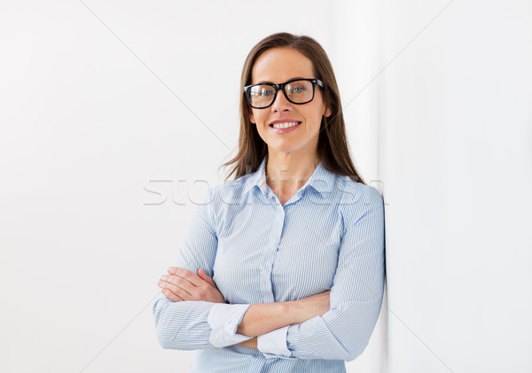 happy smiling middle aged woman in glasses Stock photo © dolgachov