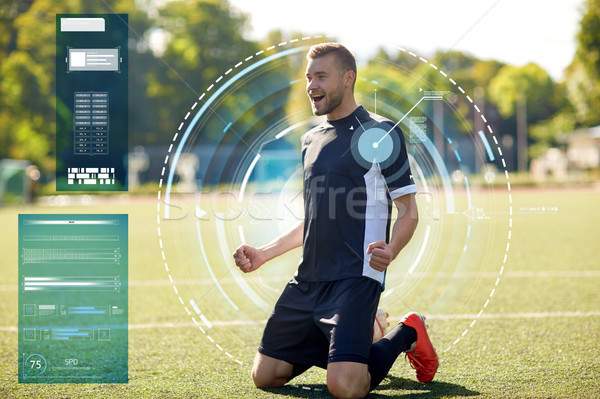 happy soccer player with ball on football field Stock photo © dolgachov