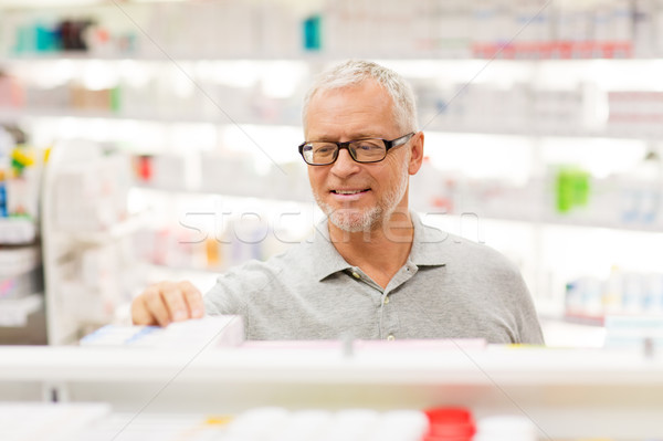 senior male customer with drug at pharmacy Stock photo © dolgachov