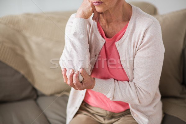 close up of senior woman having hand ache at home Stock photo © dolgachov