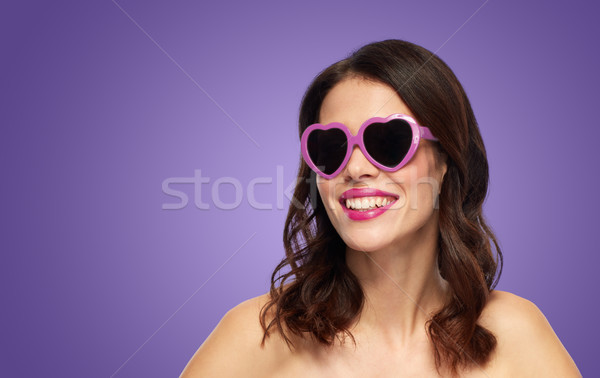 woman with heart shaped shades over ultra violet Stock photo © dolgachov