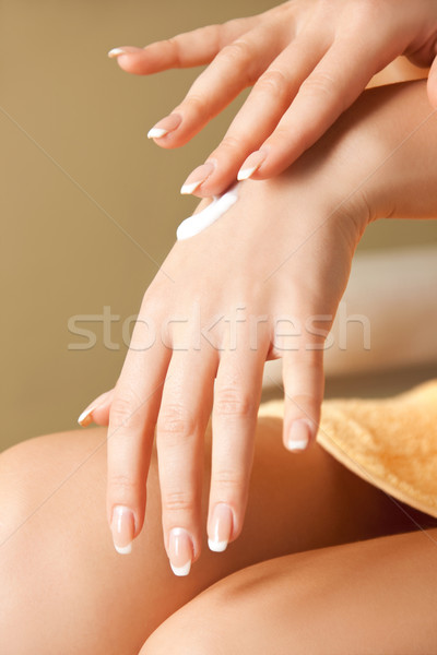 Stock photo: woman applying skin creme to hands