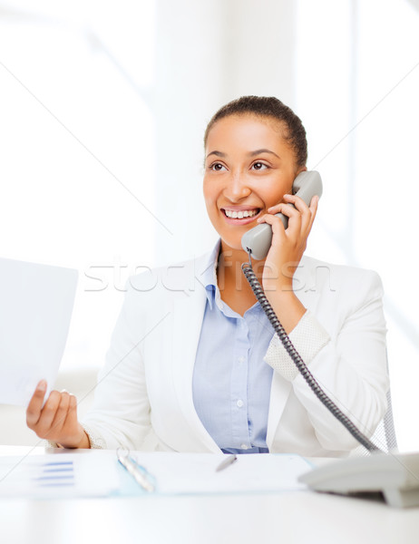 african businesswoman with phone in office Stock photo © dolgachov