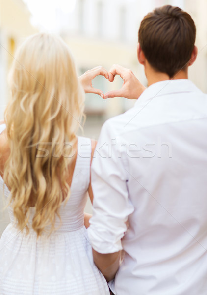 romantic couple in the city making heart shape Stock photo © dolgachov