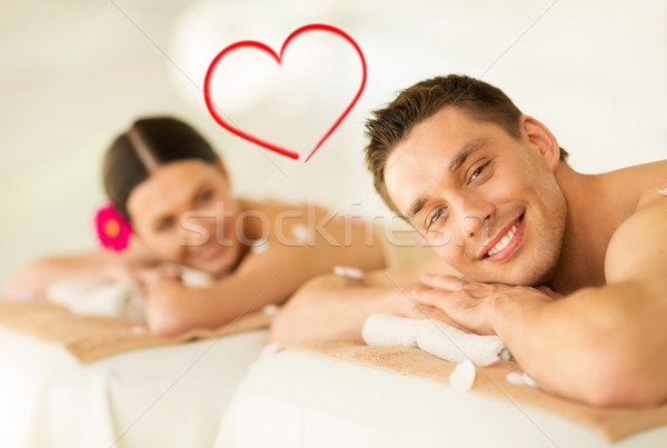 smiling couple lying on massage table in spa salon Stock photo © dolgachov