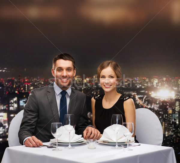 Souriant couple mains tenant restaurant vacances homme [[stock_photo]] © dolgachov