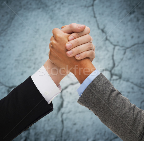 close up of hands armwrestling over concrete wall Stock photo © dolgachov