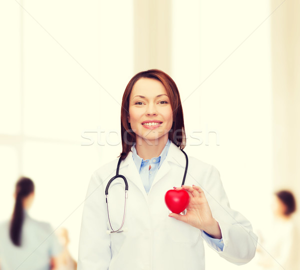 Sorridere femminile medico cuore stetoscopio sanitaria Foto d'archivio © dolgachov