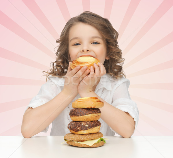 happy little girl eating junk food Stock photo © dolgachov