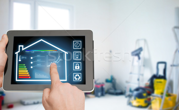 close up of tablet pc in hands setting temperature Stock photo © dolgachov