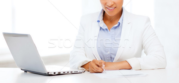 african businesswoman writing something Stock photo © dolgachov