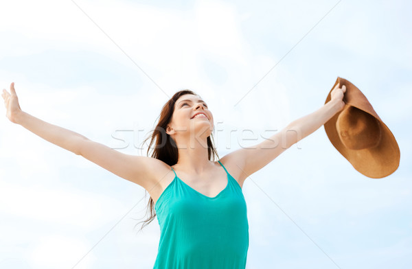 girl with hands up on the beach Stock photo © dolgachov