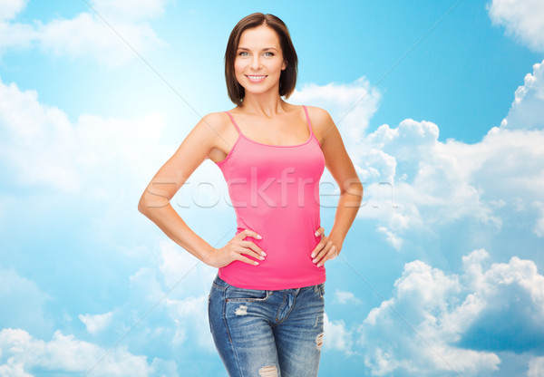woman in blank pink tank top over blue sky Stock photo © dolgachov