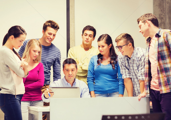 group of students and teacher with laptop Stock photo © dolgachov