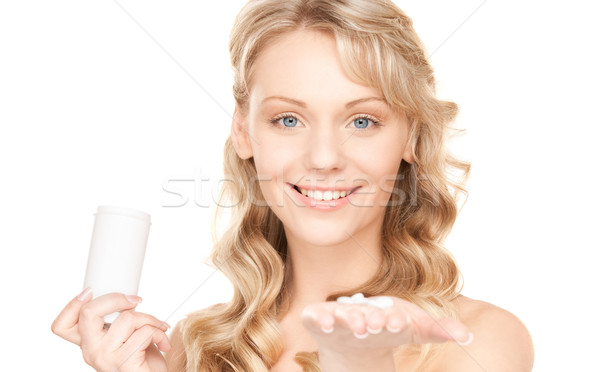Młoda kobieta pigułki zdjęcie biały kobieta medycznych Zdjęcia stock © dolgachov