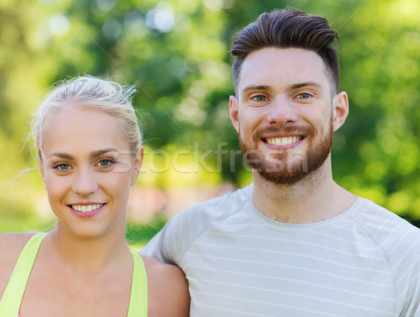 happy friends or sportsmen couple hugging outdoors Stock photo © dolgachov
