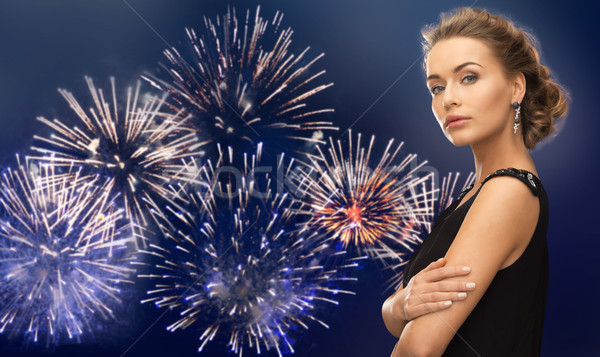 beautiful woman wearing earrings over firework Stock photo © dolgachov