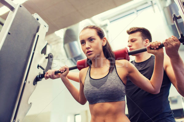 Man vrouw barbell spieren gymnasium sport Stockfoto © dolgachov