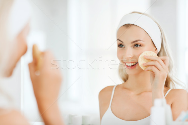 Jeune femme lavage visage éponge salle de bain beauté [[stock_photo]] © dolgachov